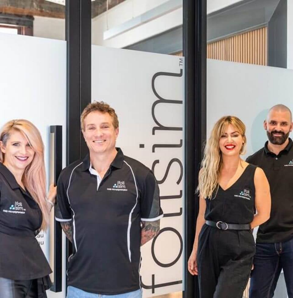 The Foli Sim team of scalp micropigmentation artists outside the studio